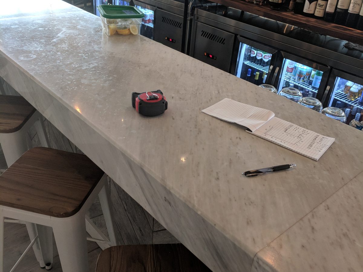 Restaurant bar marble surface before Tuffskin - visible etching and wear