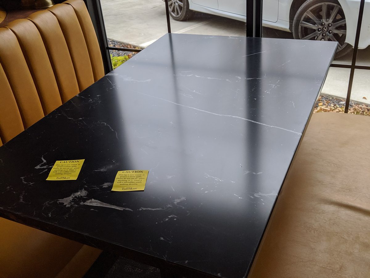 Black marble surface after restoration with Tuffskin satin finish