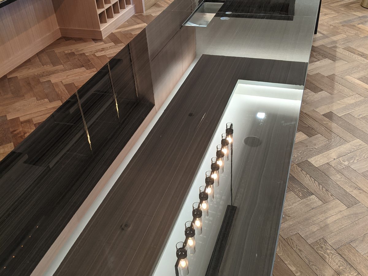 Apartment wine room with Tuffskin gloss on black marble